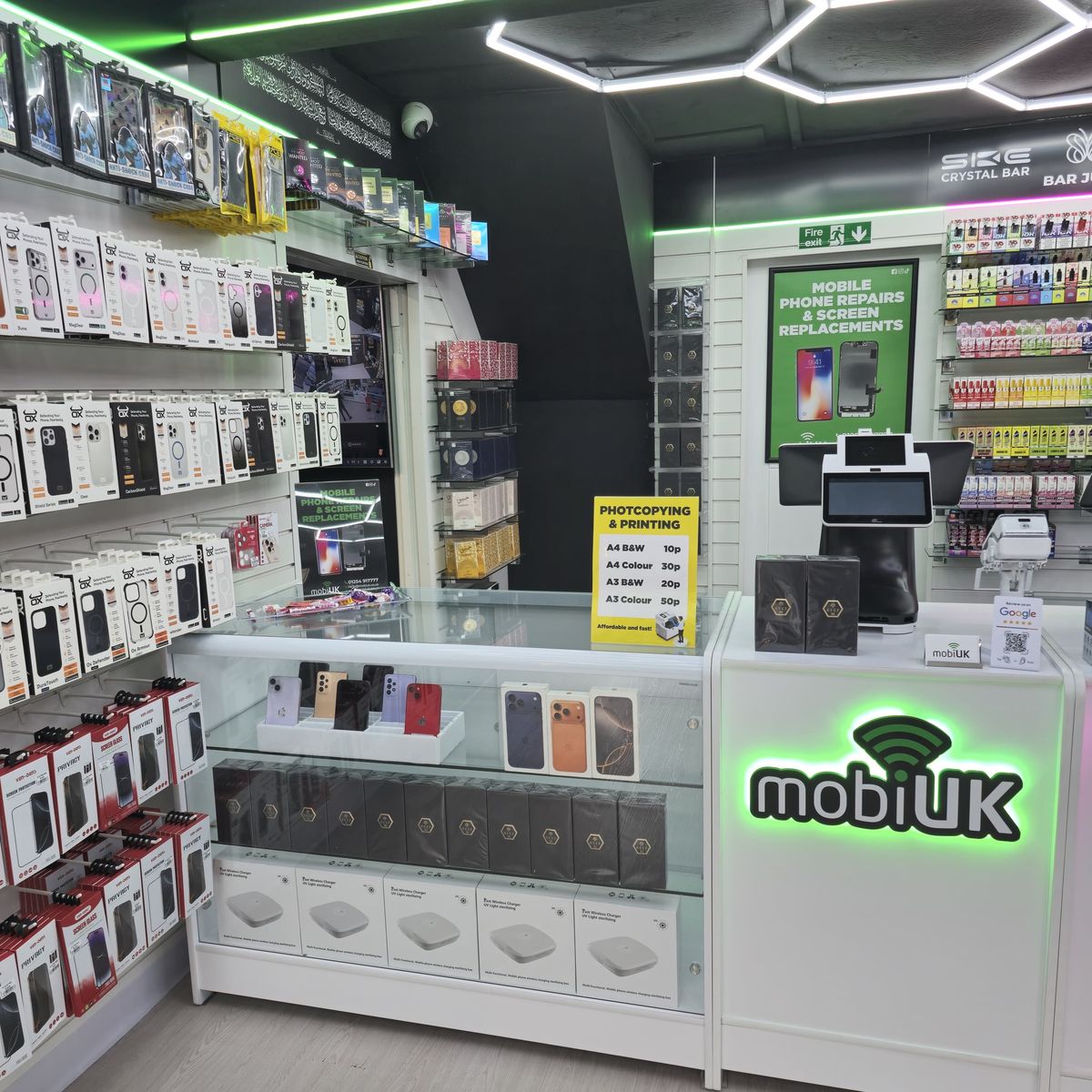 Wall of phone cases at mobiUK Accrington โ Samsung and Apple cases on display