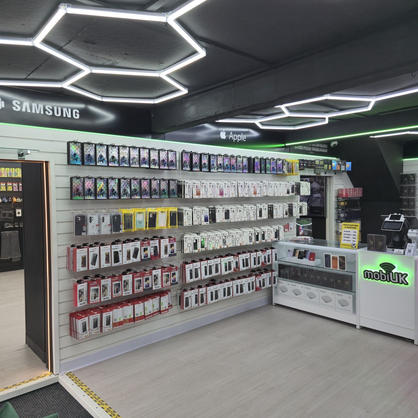 mobiUK store wide view โ cases wall with Apple and Samsung sections